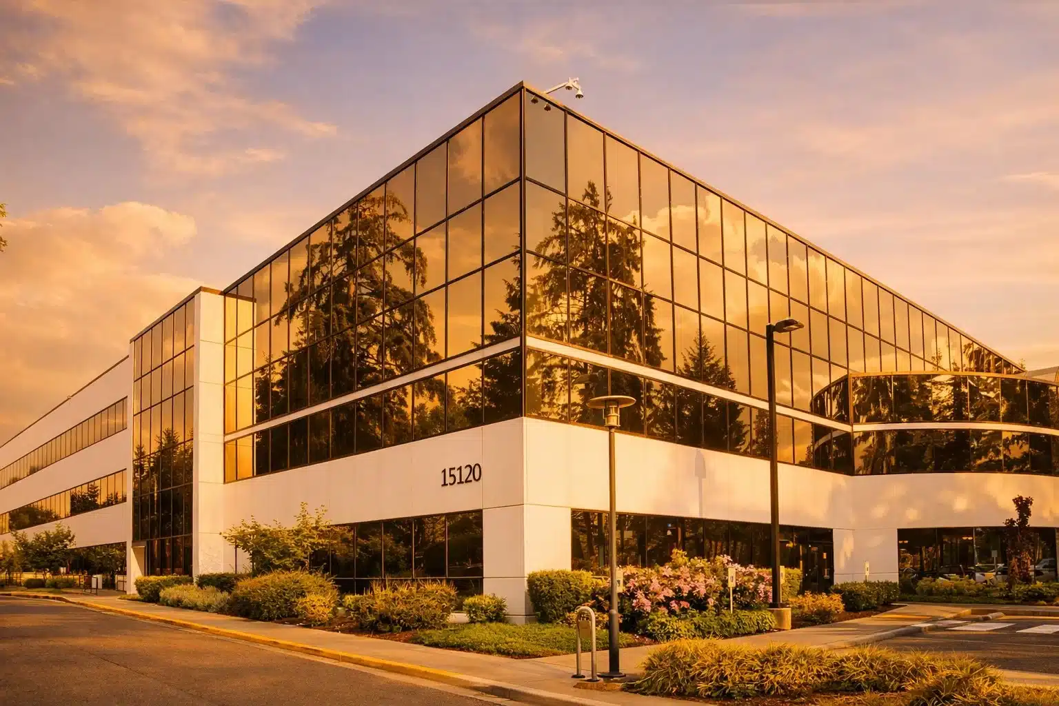 low-rise-golden Modern glass office building at sunset